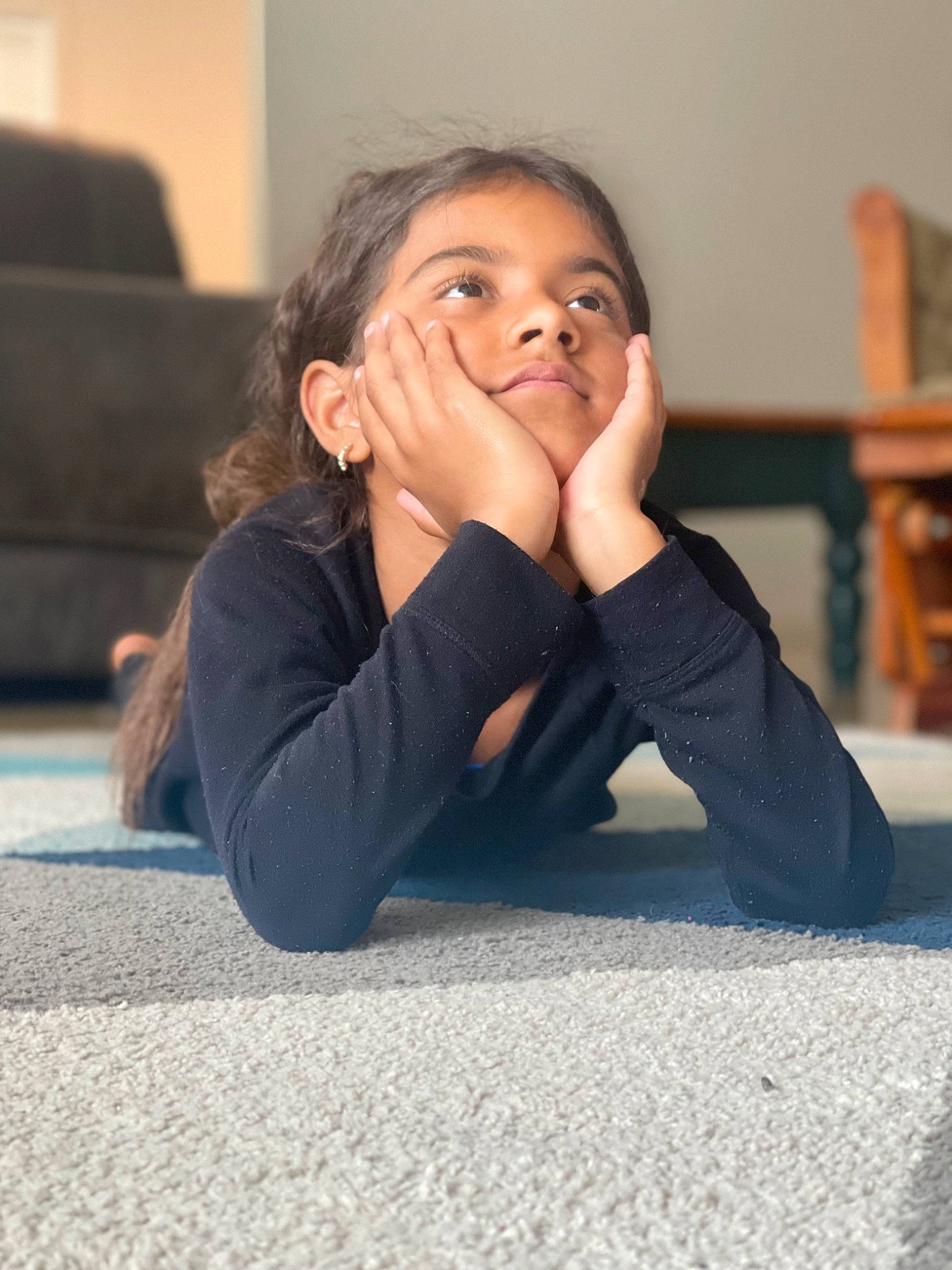 Amia is registered to the contest to win money with this photo: cheek, child, comfort, finger, flash_photography, flooring, fun, gesture, hair, happy, head, human, human_leg, joint, knee, long_hair, person, road_surface, room, sitting