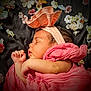 baby, sleeping, pink_cloth, headband, bow, flower_background, peaceful, infant, portrait, cute, soft_texture, wrapped, closeup, newborn, resting, child, adorable, face, skin, calm