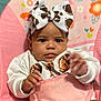 Aurora joined the competition — help win amazing prizes! baby, headband, bow, pink, cushion, flowers, hearts, football, sweatshirt, infant, child, cute, portrait, indoor, seat, clothing, hand, face, expression, young