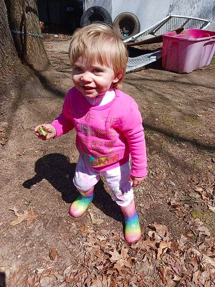 Avery is registered to the contest to win money with this photo: baby_toddler_clothing, child, fun, garden, grass, happy, human_body, leg, magenta, people_in_nature, person, pink, play, purple, sitting, smile, soil, t_shirt, toddler, tree