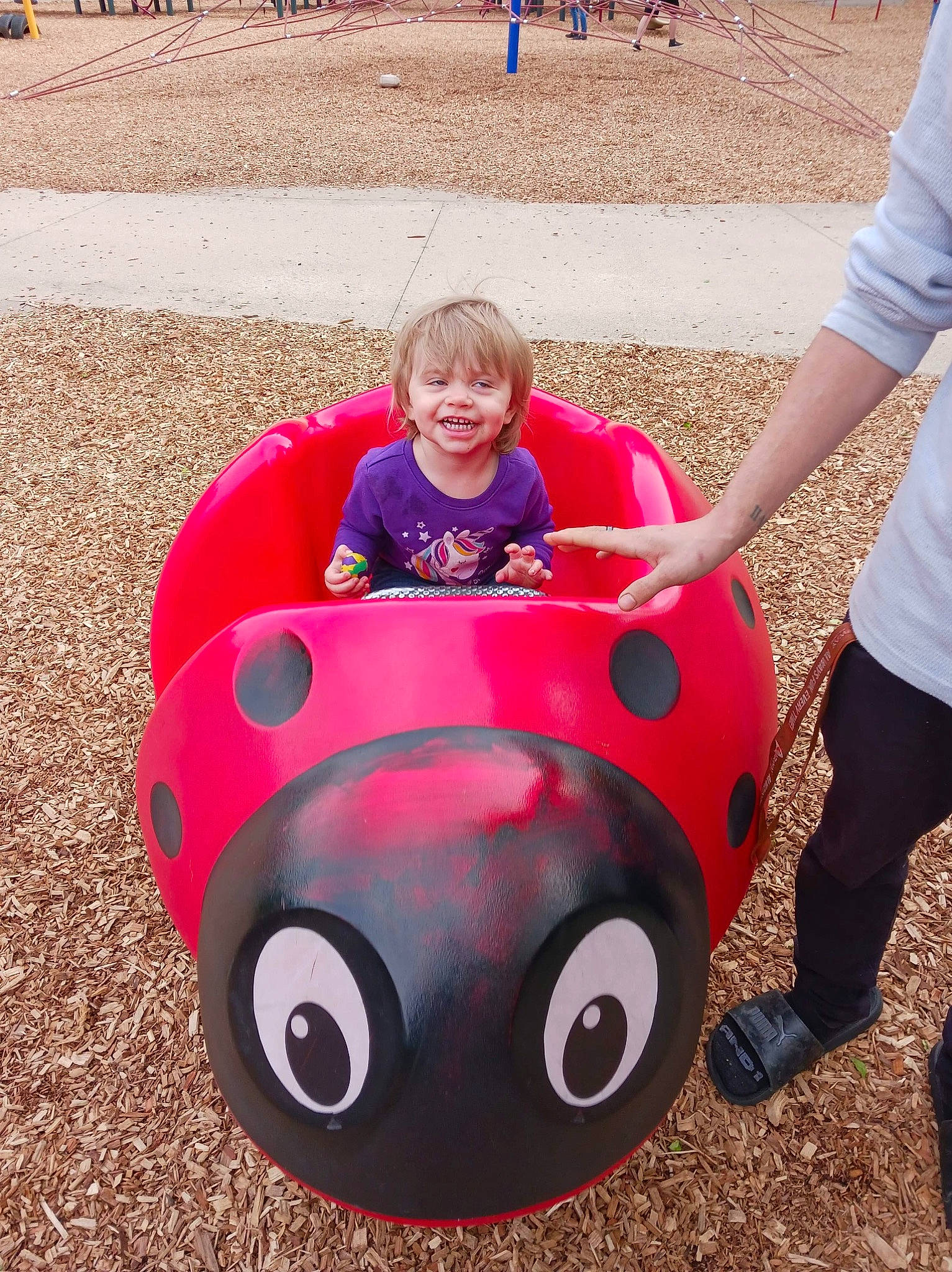 Avery is registered to the contest to win money with this photo: automotive_design, automotive_exterior, automotive_tire, bumper, car, eyewear, grass, happy, helmet, hood, joy, leisure, motor_vehicle, person, personal_protective_equipment, playground, smile, t_shirt, tire, toddler