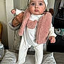 Tyssiana a rejoint le concours — aidez-le/la à gagner de superbes lots ! baby, infant, child, onesie, pink_vest, hat, pom_poms, hand, support, indoor, table, baby_bottle, cushion, face, person, clothing, curious, standing, soft_lighting, home