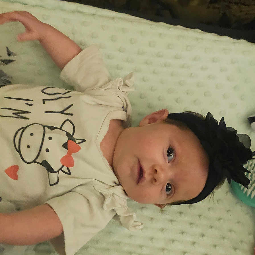 Oaklynn Yoder is registered to the contest to win money with this photo: baby, bed, blanket, bodypart, bonnet, clothing, couch, cradle, crib, face, finger, furniture, hand, hat, head, infantbed, newborn, pattern, person, t_shirt