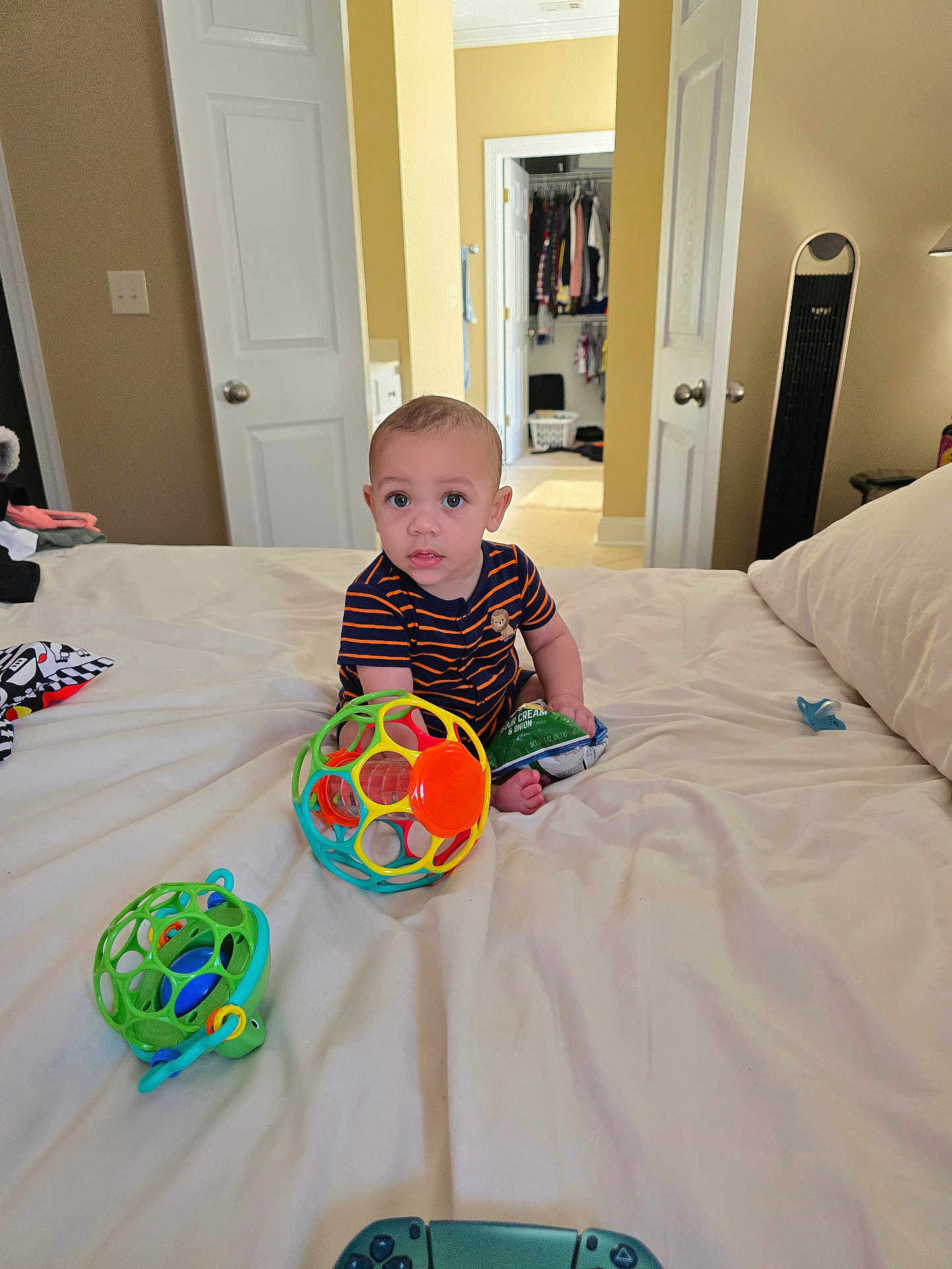 Ricky joined the competition — help win amazing prizes! toddler, child, bed, toy, ball, snack_bag, room, closet, door, blanket, pajamas, floor, furniture, indoor, curious, sitting, face, expression, playtime, home