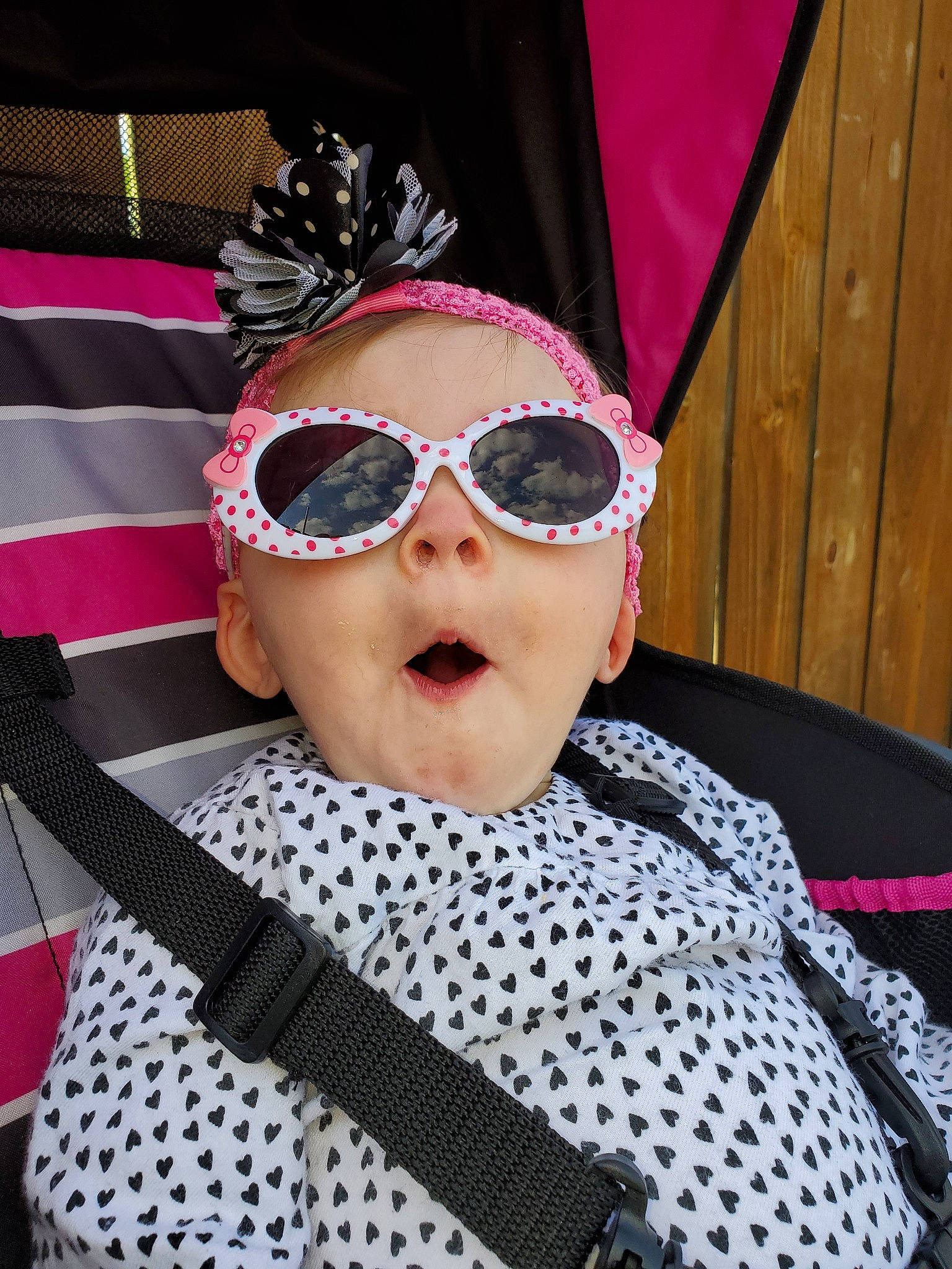 Hensley is registered to the contest to win money with this photo: black_hair, cool, costume_accessory, design, eyewear, fashion_accessory, glasses, hair_accessory, lip, magenta, pattern, person, pink, polka_dot, sunglasses, vision_care