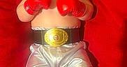 Kailas joined the competition — help win amazing prizes! baby, boxing_gloves, championship_belt, silver_shorts, black_boots, red_background, infant, portrait, boxing, costume, child, cute, serious_expression, lying_down, indoor, red, small_person, sportswear, funny, adorable
