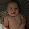 baby, smiling, diaper, cushion, mesh, playpen, child, infant, happy, skin, hand, lying, cute, indoors, comfort, pattern, person, face, young, relax