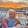 child, girl, doll, toy, sunset, ferris_wheel, marina, boat, water, handrail, sky, clouds, headband, blonde_hair, clothing, pose, outdoor, smile, portrait, evening