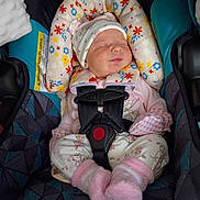 Za'Kiyah joined the competition — help win amazing prizes! baby, infant, newborn, car_seat, head_support, safety_harness, buckle, sleeping, hat, pink_socks, floral_pattern, cozy, cute, face, closed_eyes, clothing, seat, interior, checkered_sleeves, child