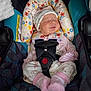 baby, infant, newborn, car_seat, head_support, safety_harness, buckle, sleeping, hat, pink_socks, floral_pattern, cozy, cute, face, closed_eyes, clothing, seat, interior, checkered_sleeves, child
