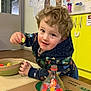 Oliver is registered to the contest to win money with this photo: baby, ball, bodypart, cutlery, diningtable, face, finger, food, furniture, hand, head, jar, person, photography, portrait, spoon, sport, sweets, table, tennis