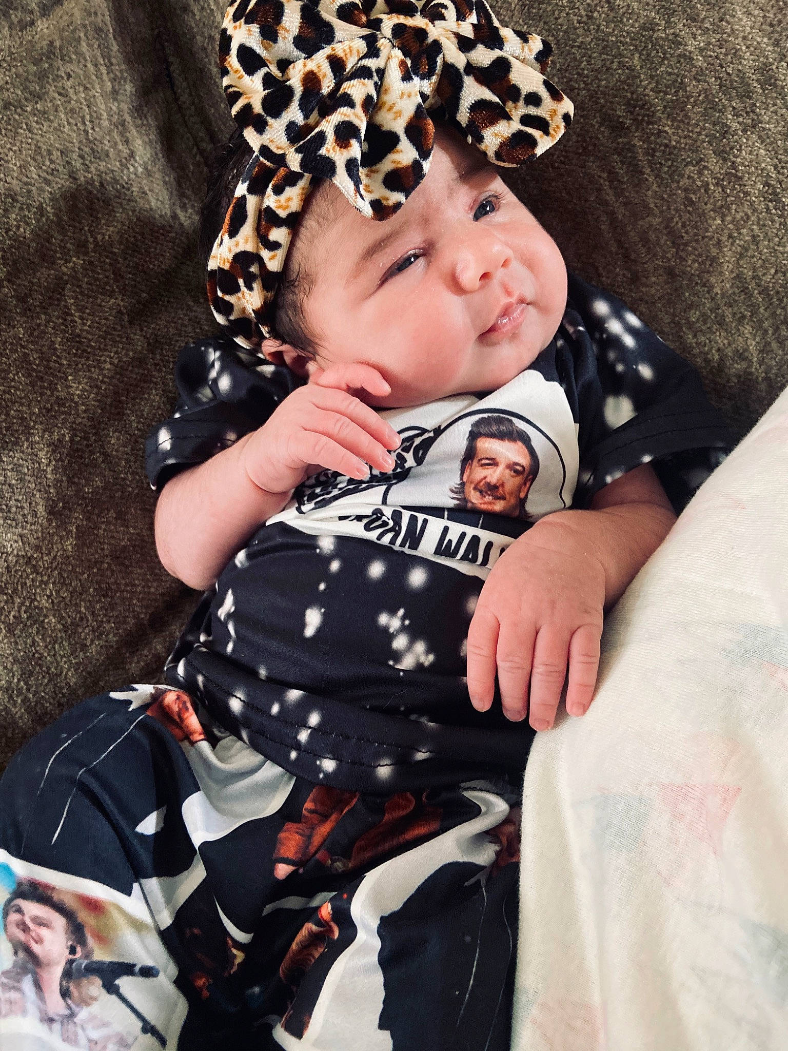 Selena is registered to the contest to win money with this photo: baby, baby_products, baby_toddler_clothing, cap, child, comfort, costume_hat, fedora, happy, hat, headband, headpiece, headwear, joy, pattern, person, pink, plaid, sitting, sleeve