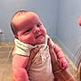 baby, infant, person, hands, indoor, blue_wall, tiled_floor, clothing, cute, face, skin, expression, portrait, newborn, holding, child, young, human, room, casual