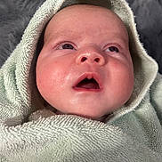 Troy joined the competition — help win amazing prizes! baby, towel, face, closeup, infant, skin, expression, eyes, mouth, soft_texture, blanket, newborn, head, wrapped, child, portrait, cute, young, indoors, cozy