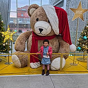 Maëlys participe au concours pour gagner de l'argent avec cette photo : boots, child, christmas_tree, decorations, denim_skirt, festive, girl, holiday, indoor, jacket, lights, ornaments, presents, railing, santa_hat, scarf, smile, star, teddy_bear, winter_clothing