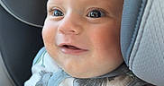 Finnegan is registered to the contest to win money with this photo: baby, child, smiling, close_up, car_seat, seat, clothing, sleeveless, animal_print, happy, cute, infant, face, portrait, skin, head, eyes, expression, indoors, person