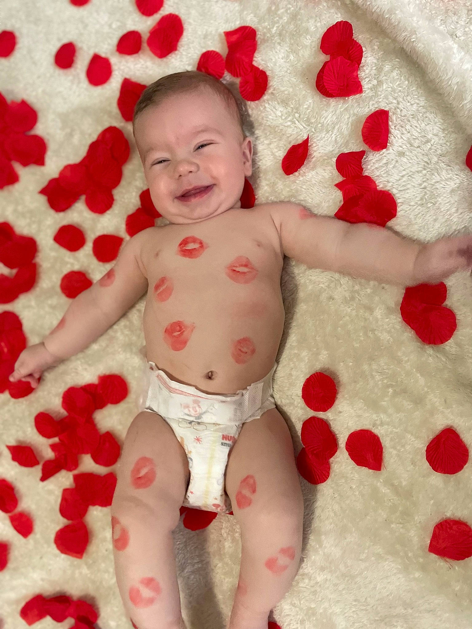 Beckham is registered to the contest to win money with this photo: arm, baby, baby_toddler_clothing, child, face, happy, head, human_body, joy, muscle, pattern, person, pink, red, skin, sleeve, smile, stomach, textile, thigh