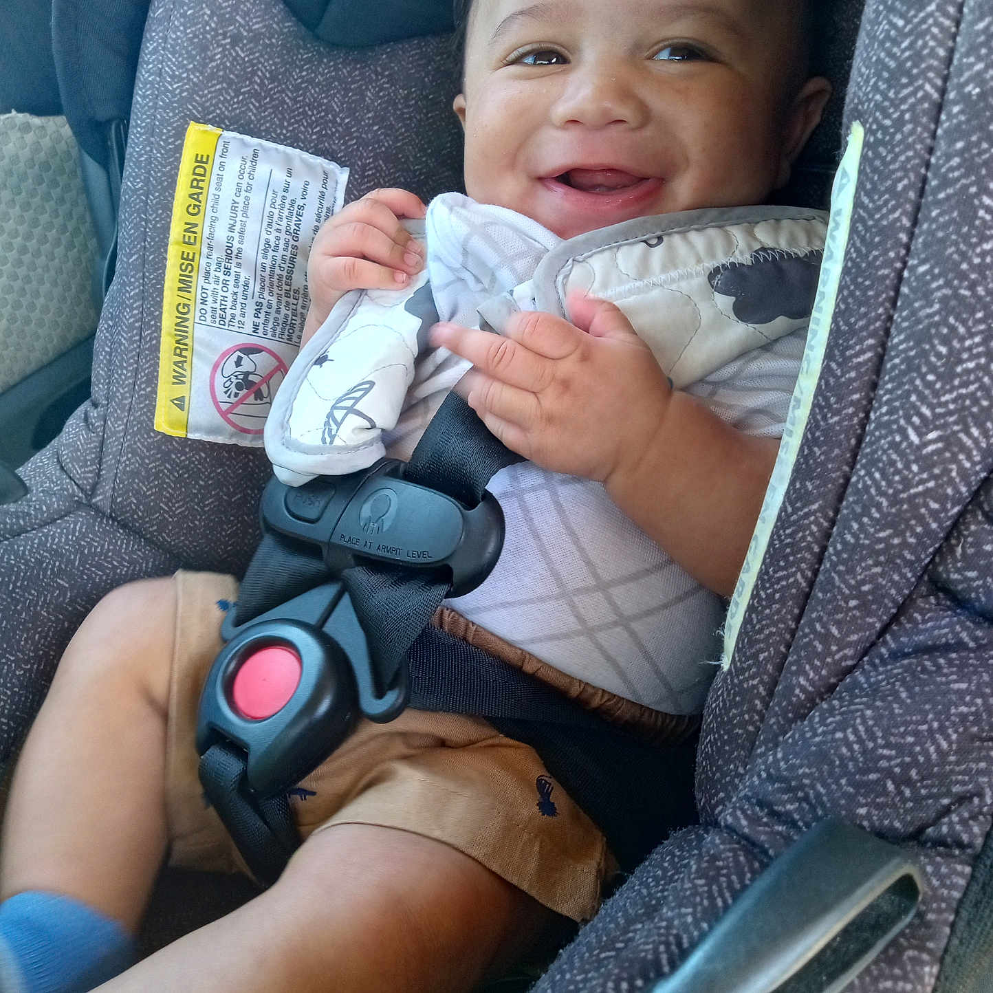Bryson joined the competition — help win amazing prizes! baby, car_seat, child, smiling, safety_harness, seatbelt, clothing, fabric, warning_label, cute, infant, hands, legs, blue_sock, happy, seat, interior, comfort, portrait, closeup