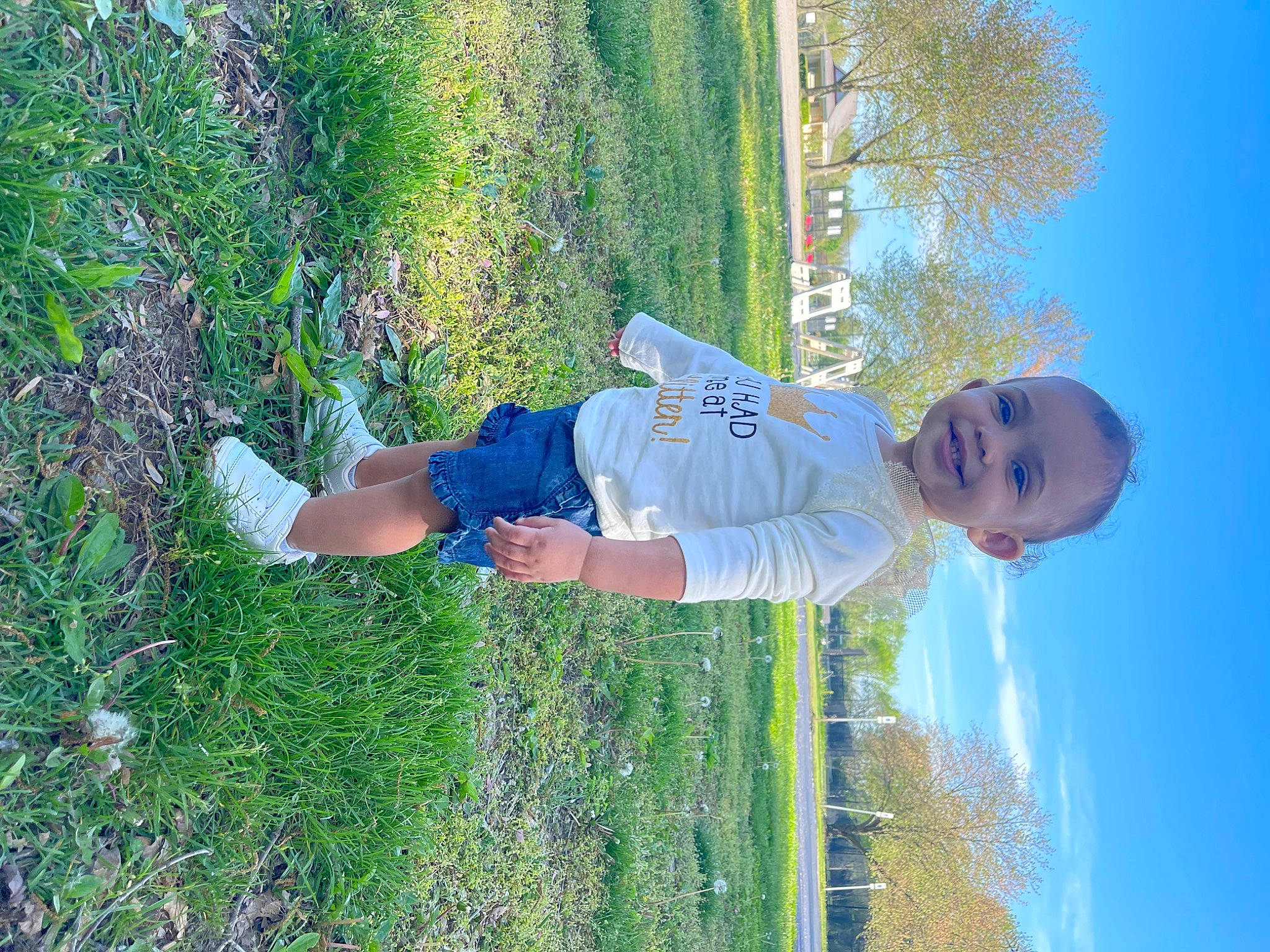 Caleyah is registered to the contest to win money with this photo: azure, baby, blue, elbow, electric_blue, fun, grass, grass_family, grassland, groundcover, happy, joy, leaf, leisure, people_in_nature, person, plant, shrub, sky, t_shirt