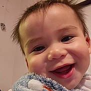 Tobias joined the competition — help win amazing prizes! baby, smiling, close_up, blanket, happy, face, child, indoors, cute, portrait, toddler, soft_texture, warmth, joy, expression, human, skin, head, cheeks, eyes