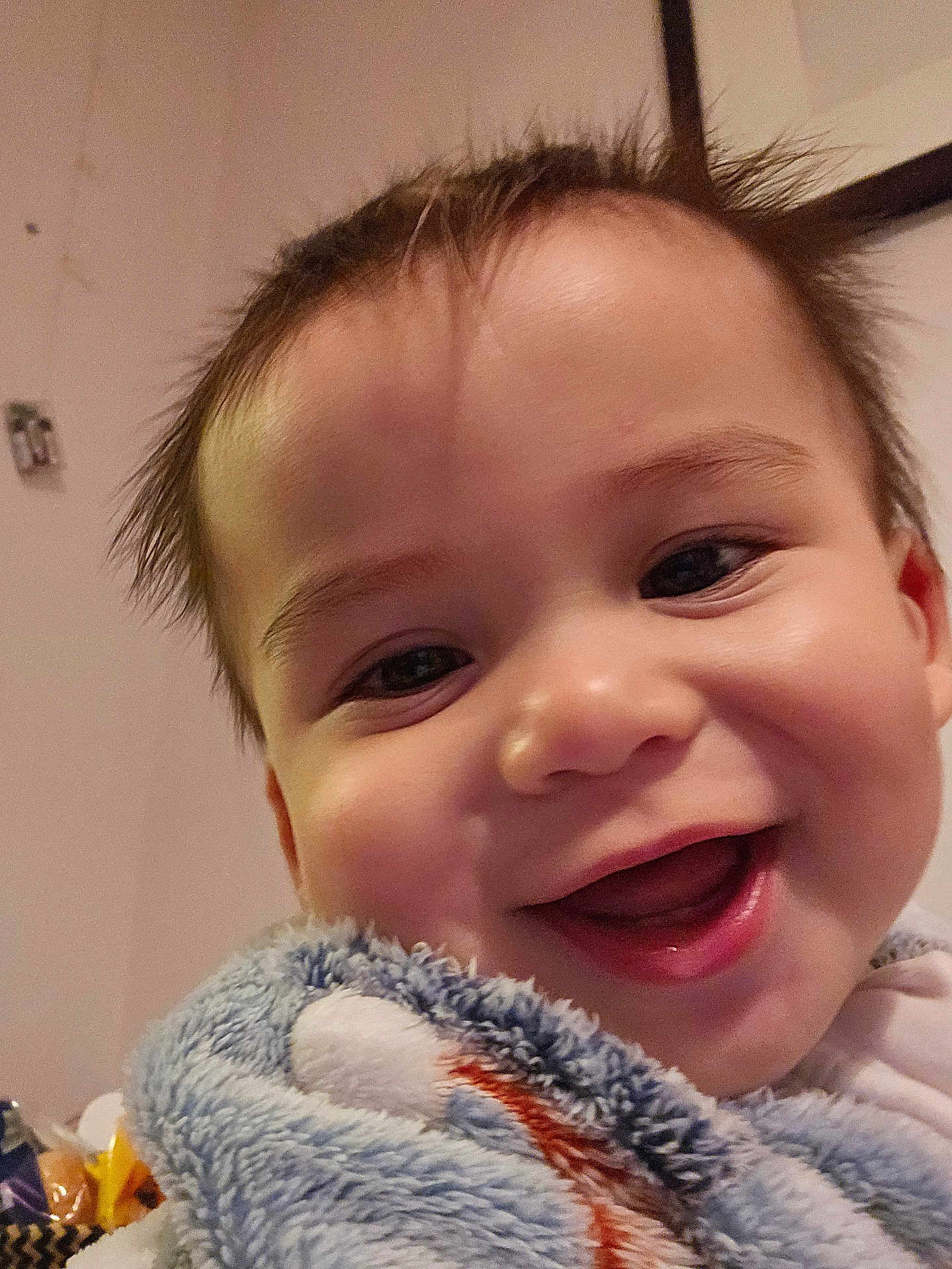 Tobias joined the competition — help win amazing prizes! baby, smiling, close_up, blanket, happy, face, child, indoors, cute, portrait, toddler, soft_texture, warmth, joy, expression, human, skin, head, cheeks, eyes