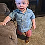 Ryler joined the competition — help win amazing prizes! toddler, child, blue_eyes, standing, indoor, carpet, couch, shirt, shorts, shoes, living_room, furniture, curious, young_child, person, home, casual_clothing, cute, baby, portrait