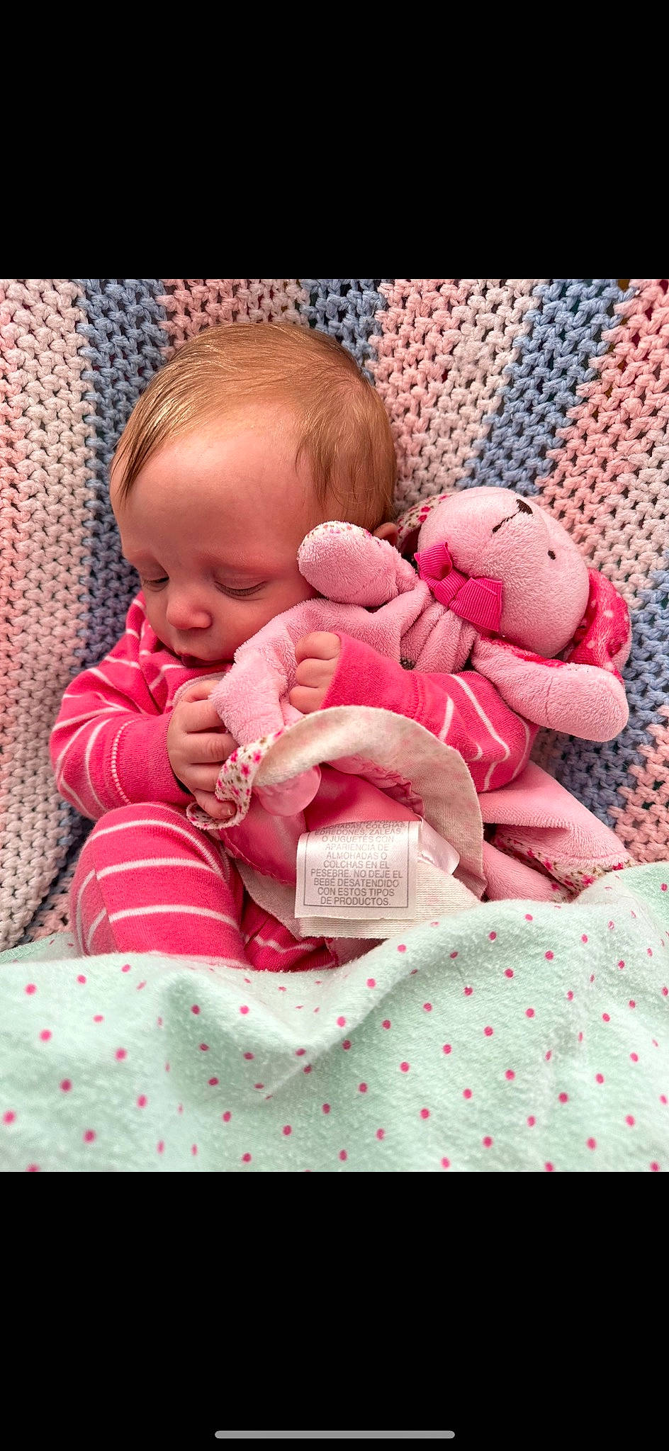 Berlin is registered to the contest to win money with this photo: baby, baby_products, baby_sleeping, baby_toddler_clothing, carmine, cheek, child, comfort, eye, finger, happy, linens, mouth, pattern, person, pink, skin, stuffed_toy, textile, toddler