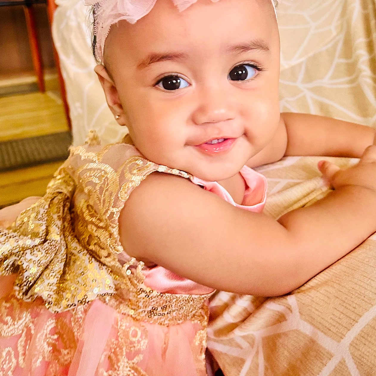 Meliame Vaenuku is registered to the contest to win money with this photo: baby, child, closeup, cute, dress, elegant, face, fashion, gold, happy, headband, indoor, infant, pattern, person, pink, portrait, smiling, tablecloth, toddler