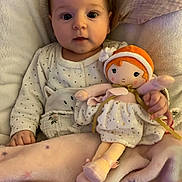 Charlie participe au concours pour gagner de l'argent avec cette photo : baby, bed, blanket, child, comfort, cozy, cute, doll, fabric, indoors, infant, person, pillow, portrait, resting, sleep, sleepwear, smiling, soft_toys, toy