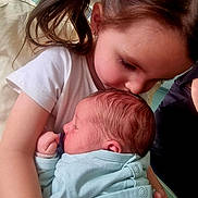 Léonie a rejoint le concours — aidez-le/la à gagner de superbes lots ! child, baby, newborn, girl, pigtails, hug, kiss, indoor, blanket, clothing, person, family, love, tenderness, affection, cute, portrait, infant, holding, skin