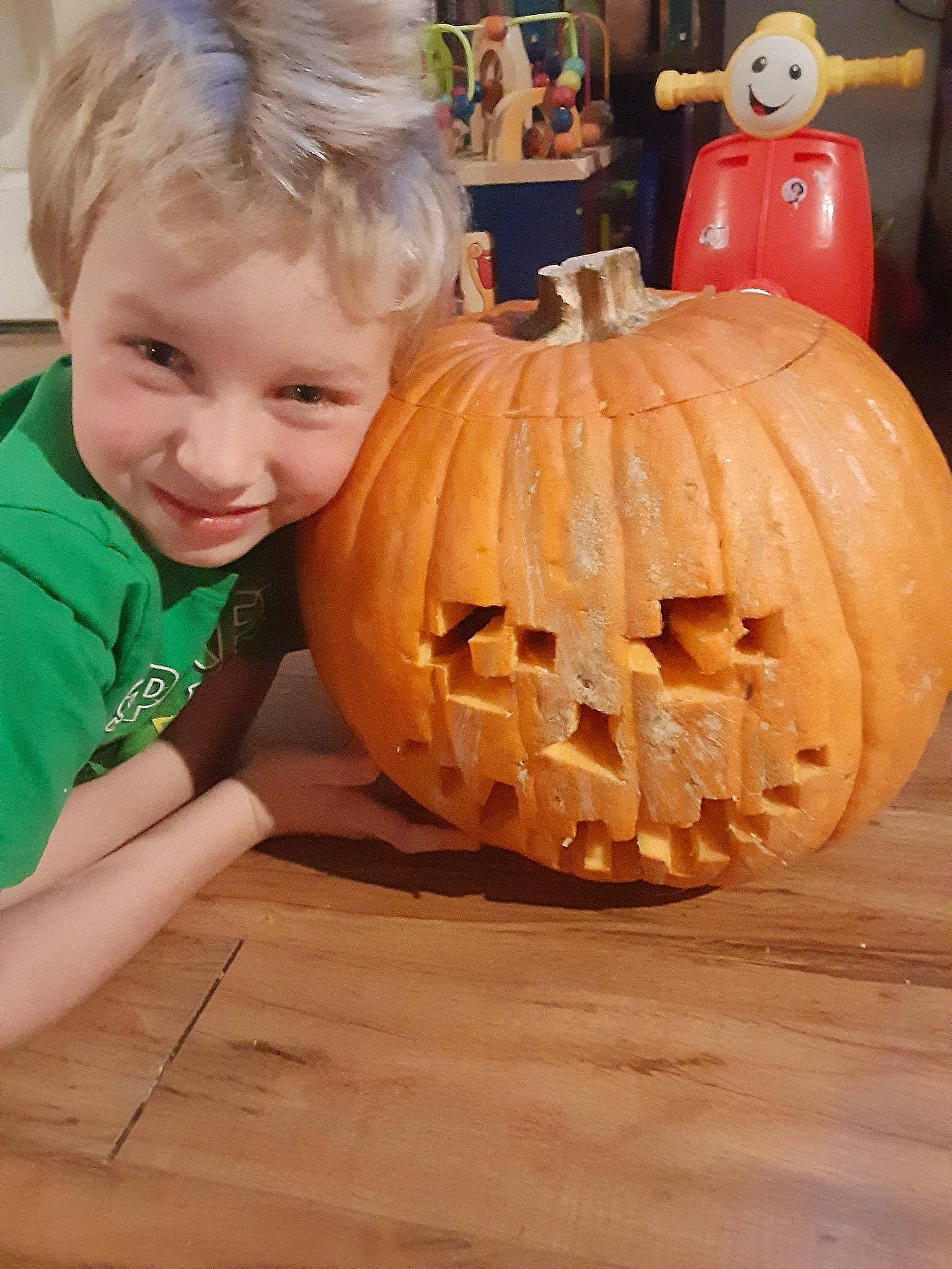 Nicholas joined the competition — help win amazing prizes! art, calabaza, creative_arts, cucurbita, flooring, fruit, gourd, head, jack_o_lantern, joy, natural_foods, orange, person, plant, produce, pumpkin, smile, squash, toddler, vegetable