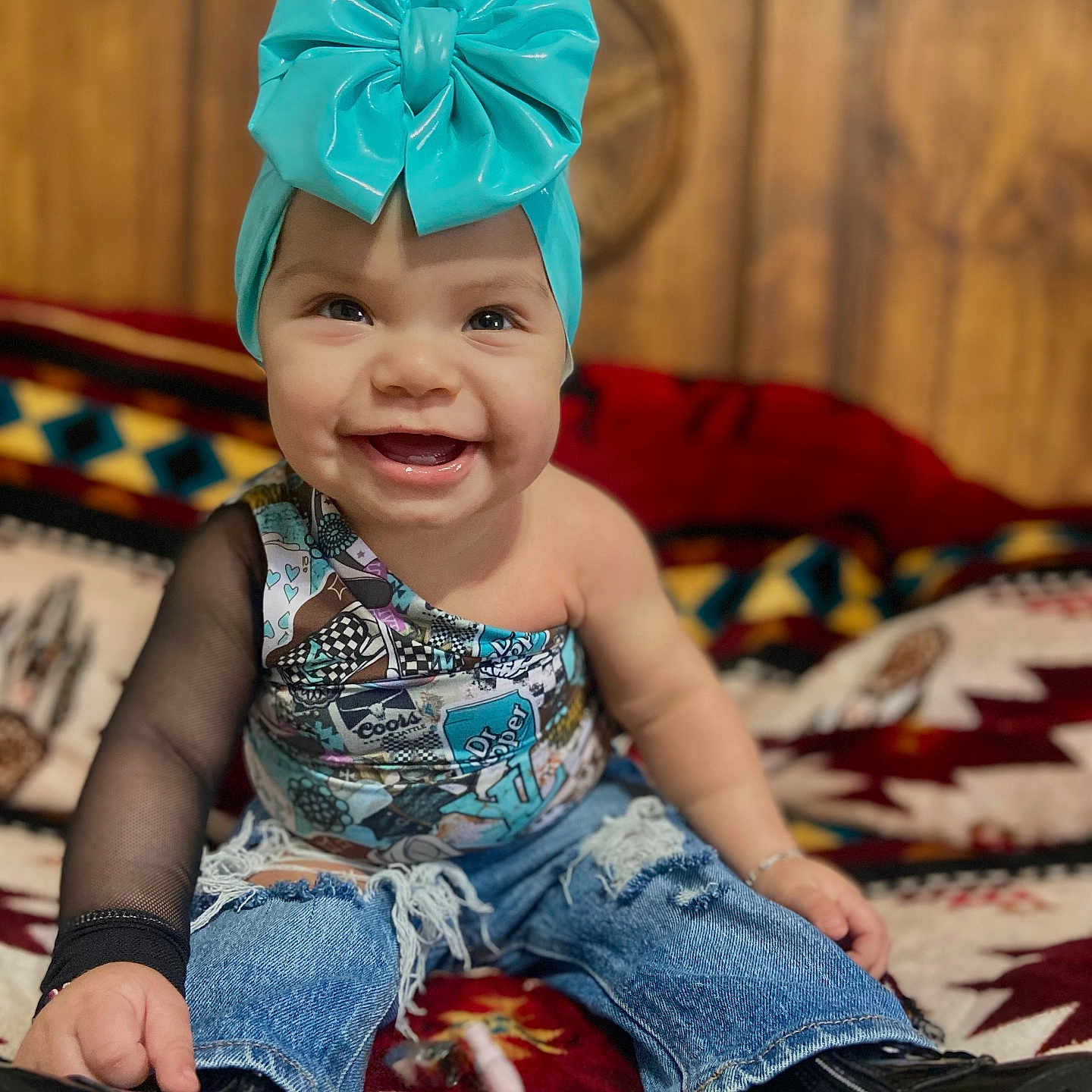 Kataleya is registered to the contest to win money with this photo: baby, babylaughing, bed, cap, clothing, dress, face, footwear, furniture, happy, hat, head, indoors, jeans, pants, person, photography, portrait, shoe, sitting