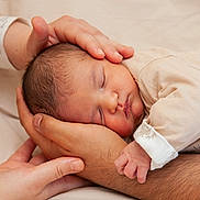 Sirat participe au concours pour gagner de l'argent avec cette photo : newborn, baby, sleeping, hands, adult_hands, cradling, close_up, skin, infant, peaceful, beige, soft_lighting, portrait, family, tenderness, comfort, clothing, bed, resting, caring