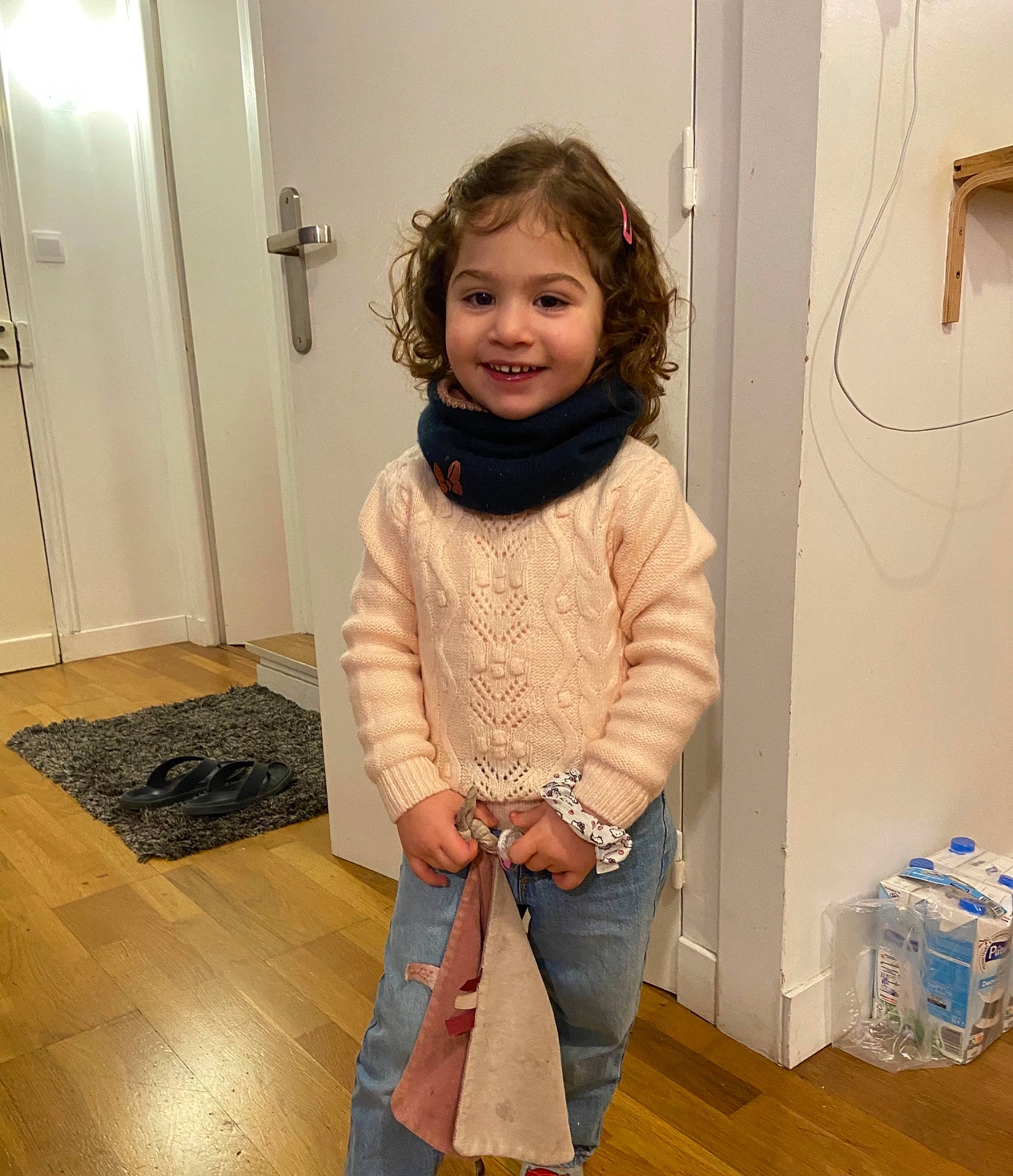 Noor participe au concours pour gagner de l'argent avec cette photo : baby_toddler_clothing, door, floor, flooring, hair, happy, hardwood, iris, joint, joy, knee, laminate_flooring, outerwear, person, shoulder, sleeve, smile, standing, thigh, toddler