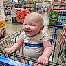 baby, shopping_cart, walmart, smiling, child, grocery_store, aisle, clothing, happy, infant, retail, store, person, retail_environment, shopping, cute, holding, metal, plastic, indoor