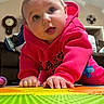 Raynie joined the competition — help win amazing prizes! baby, child, crawling, hoodie, pink_clothing, play_mat, indoor, carpet, hands, face, blue_eyes, curious, cute, person, toddler, floor, toy, home, living_room, expression