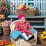 baby, child, flower_headband, pink_dress, armchair, tulips, basket, easter_eggs, wooden_bench, white_picket_fence, rustic, spring, smiling, indoor, decor, colorful, happy, headband, floor, portrait
