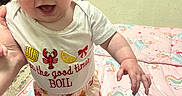 Raynie is registered to the contest to win money with this photo: baby, child, smiling, indoor, blanket, unicorn, clothing, toddler, person, hand, floor, furniture, shirt, pants, cute, happy, face, eyes, playtime, colorful