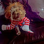 Brownie joined the competition — help win amazing prizes! dog, small_dog, wig, costume, striped_clothing, tongue_out, leather_couch, pillow, purple_pillow, indoor, pet, cute, playful, fur, brown_fur, sitting, home, decor, sparkle_effect, funny