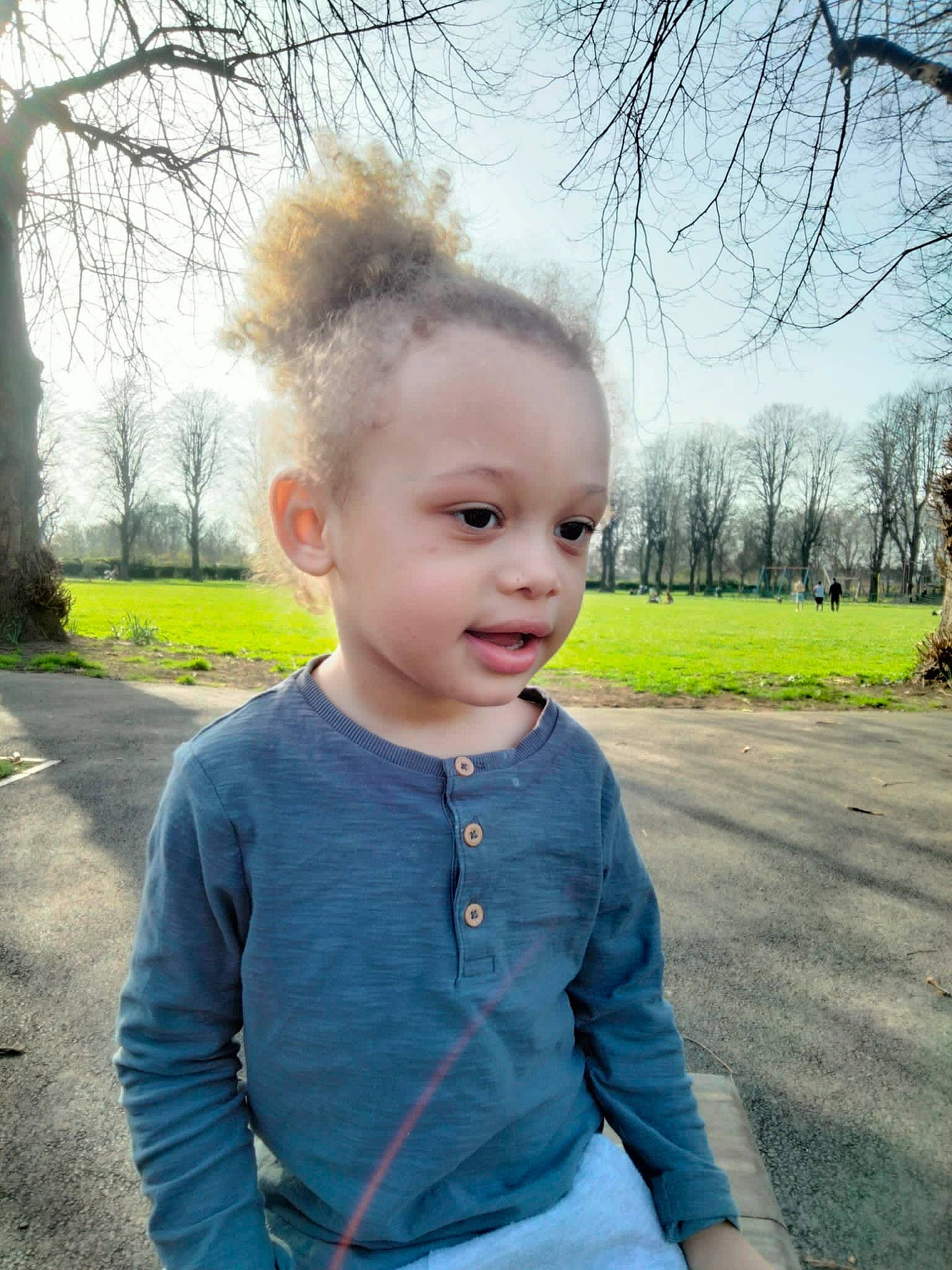 Logan is registered to the contest to win money with this photo: asphalt, baby, baby_toddler_clothing, beauty, blond, electric_blue, face, flash_photography, grass, hair, hairstyle, happy, iris, lip, person, plant, shoulder, sky, sleeve, toddler