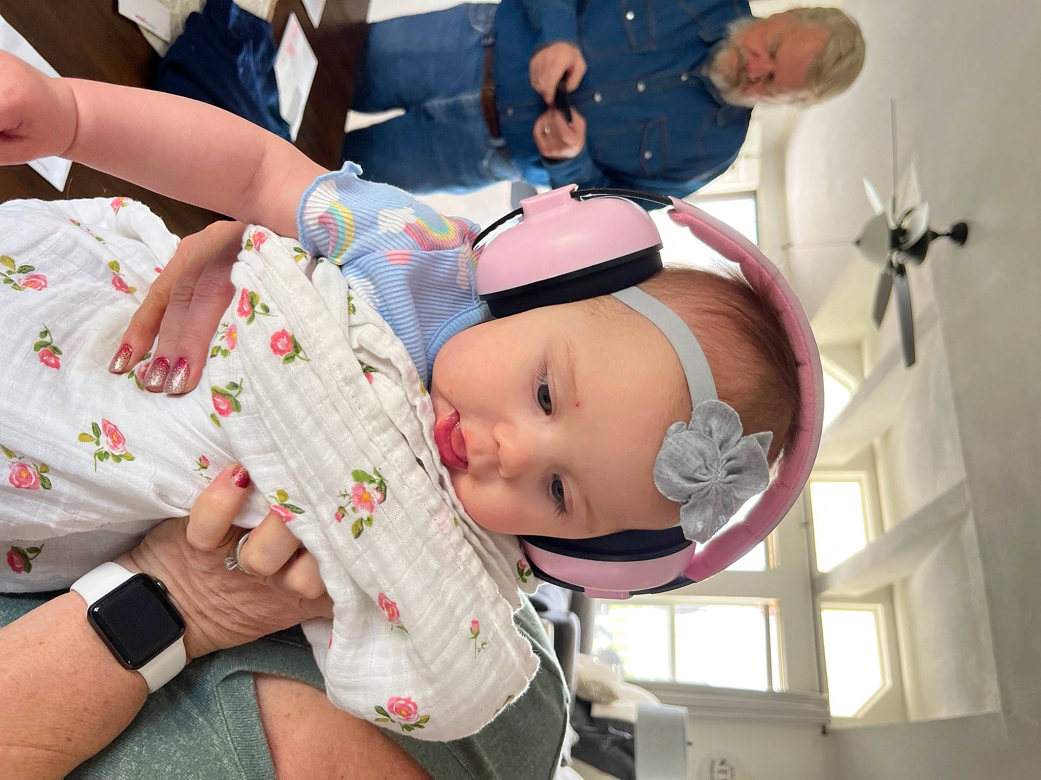 Ahria is registered to the contest to win money with this photo: arm, baby, ceiling_fan, child, clothing, event, finger, fun, hand, happy, hat, headwear, leisure, person, pink, plant, shorts, sitting, skin, t_shirt