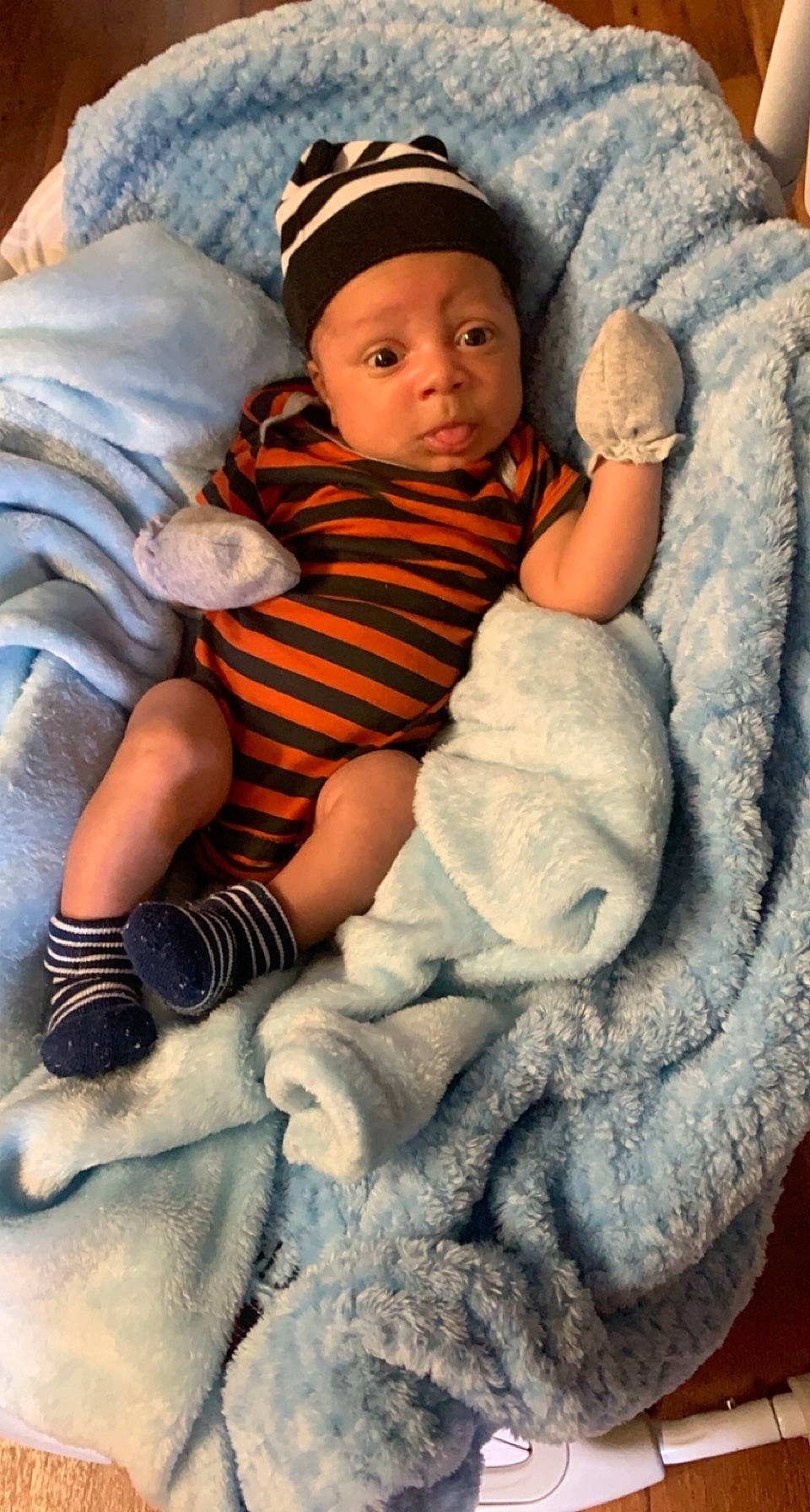 Jesiah is registered to the contest to win money with this photo: baby, baby_toddler_clothing, cap, cheek, child, comfort, eye, flash_photography, happy, headwear, human_body, iris, lap, linens, pattern, person, sitting, skin, sock, toddler