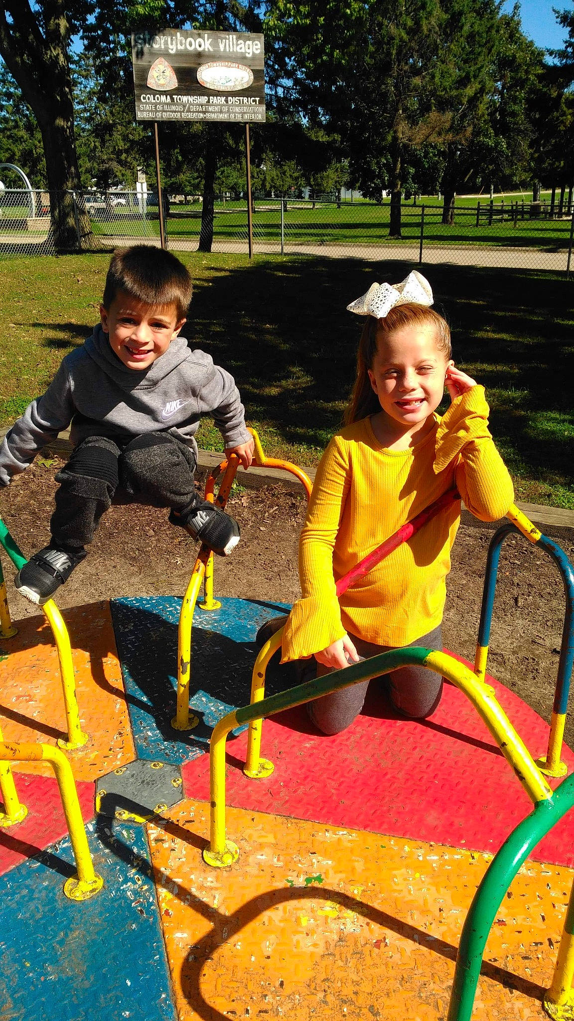 Kailianna is registered to the contest to win money with this photo: child, city, fun, human_settlement, joy, leisure, outdoor_play_equipment, park, person, play, playground, public_space, recreation, smile, swing, toddler, tree, vacation