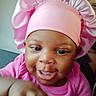 Nevaeh is registered to the contest to win money with this photo: baby, child, pink_bonnet, pink_clothing, smiling, happy, close_up, indoor, infant, cute, tiny_hands, face, person, headwear, portrait, joyful, expression, sitting, skin, young
