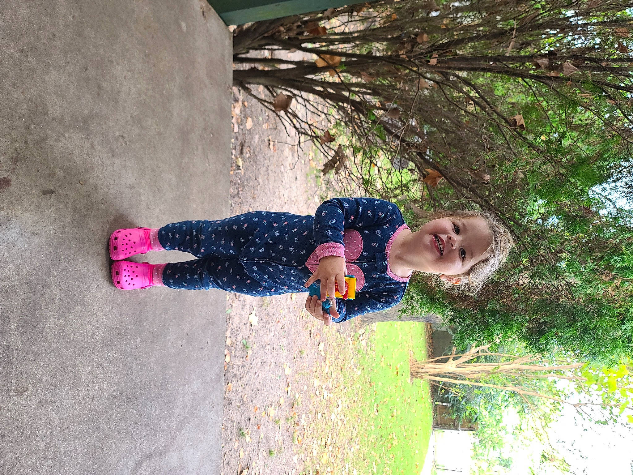 Maevery is registered to the contest to win money with this photo: baby_toddler_clothing, child, concrete, fun, grass, happy, joy, leisure, magenta, people_in_nature, person, plant, shadow, smile, toddler, tree, water