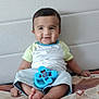 Gurfateh Singh joined the competition — help win amazing prizes! baby, child, smiling, sitting, toy, blue_toy, bedspread, couch, indoor, happy, clothing, shorts, bracelet, feet, face, person, infant, home, cute, young