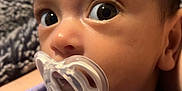 Zemira joined the competition — help win amazing prizes! alert, baby, blanket, close_up, cozy, curious, face, flooring, head, indoors, infant, pacifier, person, portrait, purple_clothing, skin, swaddled, wide_eyes, wood_floor, young_child