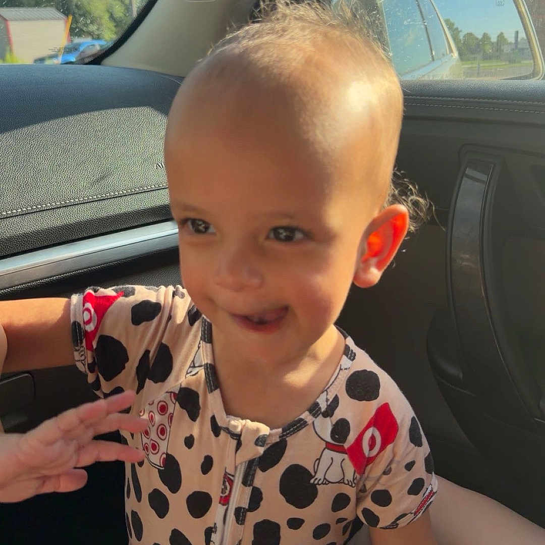 Zemira joined the competition — help win amazing prizes! toddler, child, car_interior, sunlight, smiling, onesie, playful, hand, window, seat, seatbelt, face, head, hair, clothing, expression, indoor, daylight, person, cute