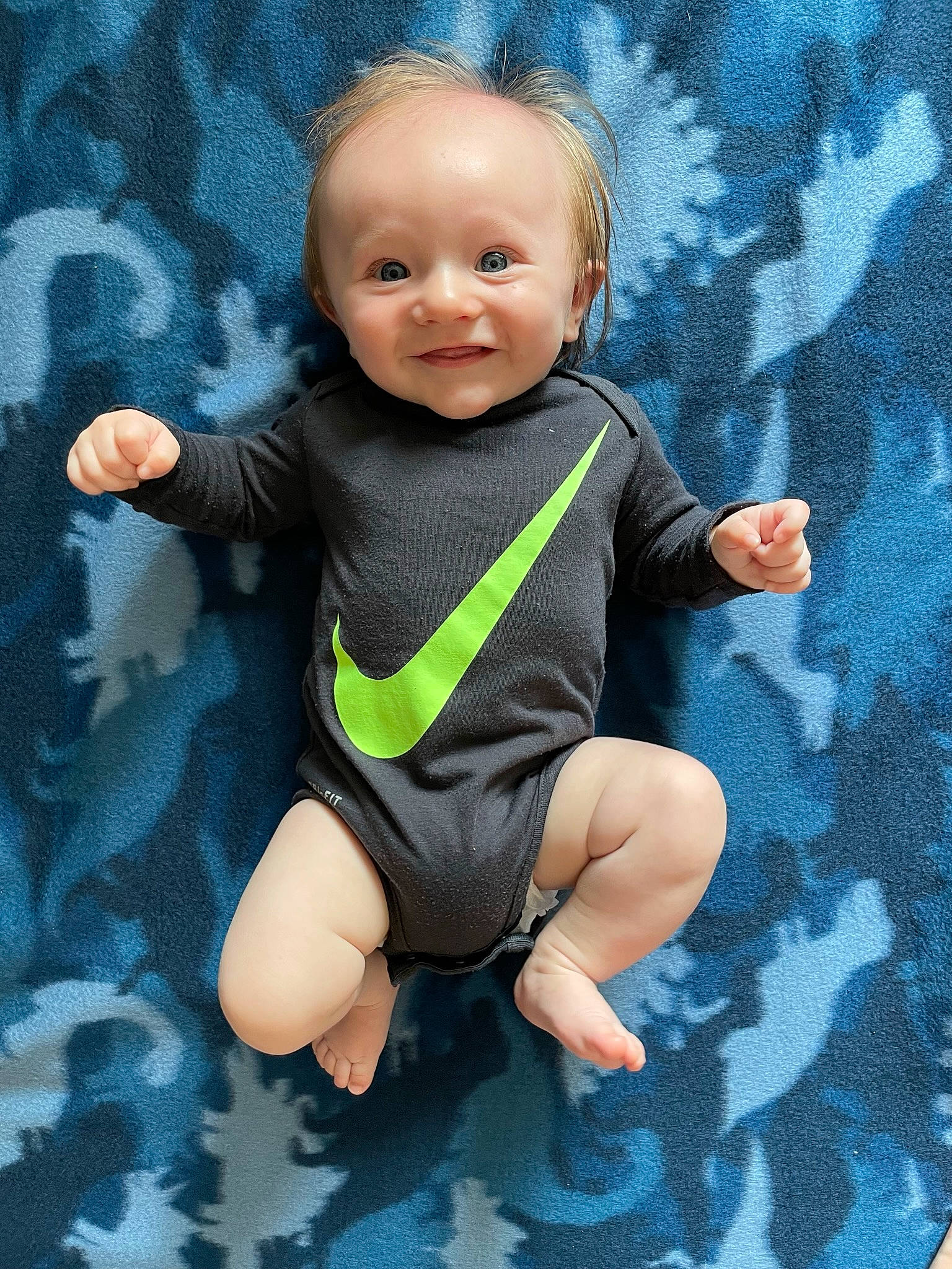 Lane joined the competition — help win amazing prizes! azure, baby, baby_toddler_clothing, cheek, comfort, electric_blue, eye, finger, fun, gesture, grass, happy, human_body, infant_bodysuit, joint, pattern, person, sleeve, smile, thumb