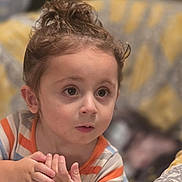 Brando joined the competition — help win amazing prizes! child, toddler, curly_hair, striped_shirt, indoor, blanket, bedroom, portrait, hands, cute, expression, young_child, curious, soft_light, face, person, brown_hair, home, casual, cozy